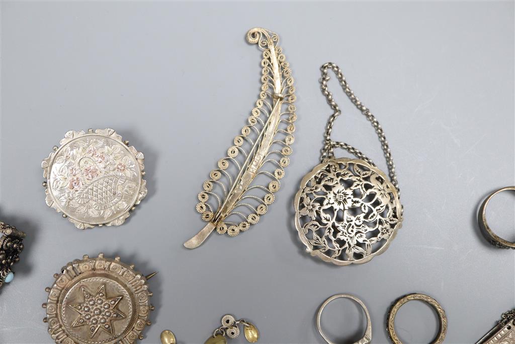 Mixed jewellery including silver brooch and white metal bracelets.